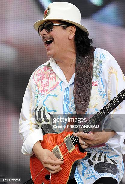 Guitarist and singer Carlos Santana performs on July 21, 2013 during the Vieilles Charrues music Festival in Carhaix-Plouguer, western of France. AFP...