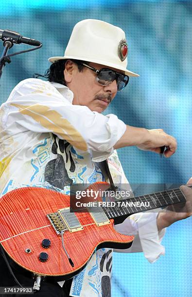 Guitarist and singer Carlos Santana performs on July 21, 2013 during the Vieilles Charrues music Festival in Carhaix-Plouguer, western of France. AFP...