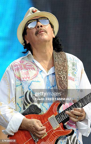 Guitarist and singer Carlos Santana performs on July 21, 2013 during the Vieilles Charrues music Festival in Carhaix-Plouguer, western of France. AFP...