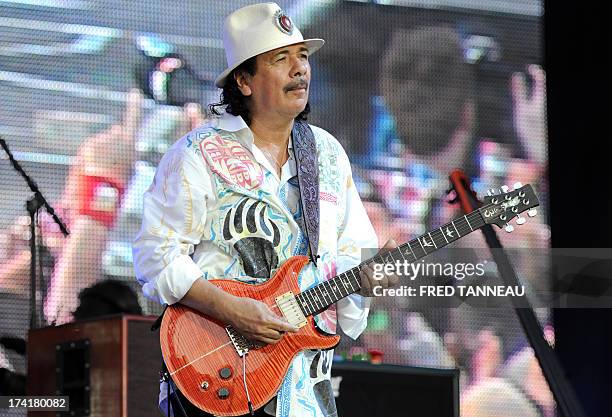 Guitarist and singer Carlos Santana performs on July 21, 2013 during the Vieilles Charrues music Festival in Carhaix-Plouguer, western of France. AFP...