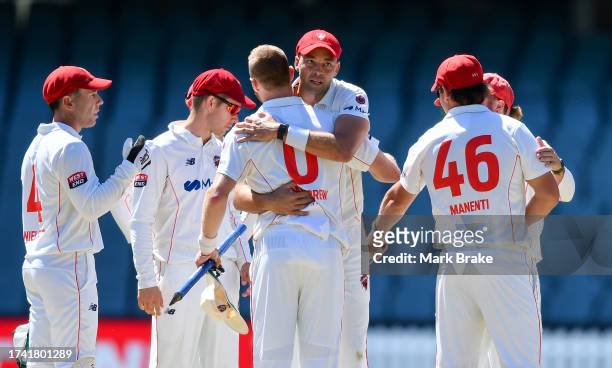 Harry Conway hugs Nathan McAndrew as the Redbacks celebrate the win after the Sheffield Shield match between South Australia and New South Wales at...