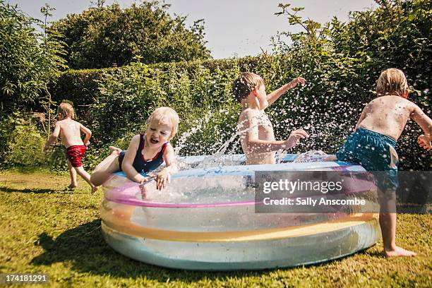 children playing in a paddling pool - paddling pool stock pictures, royalty-free photos & images