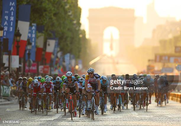 The peloton carges away from the Arc d'Triomphe during the twenty first and final stage of the 2013 Tour de France, a processional 133.5KM road stage...