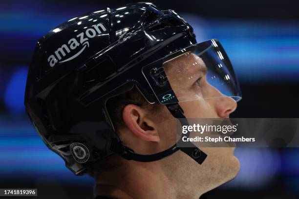 The Amazon logo detail is seen on the helmet of Jamie Oleksiak of the Seattle Kraken during warmups before the game against the Colorado Avalanche at...