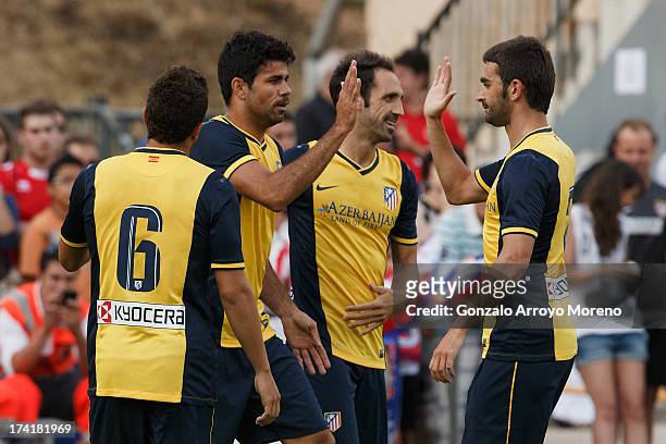 Diego Costa of Atletico de Madrid celebrates scoring their opening goal with teammates during the Jesus Gil y Gil Trophy between Club Atletico de...