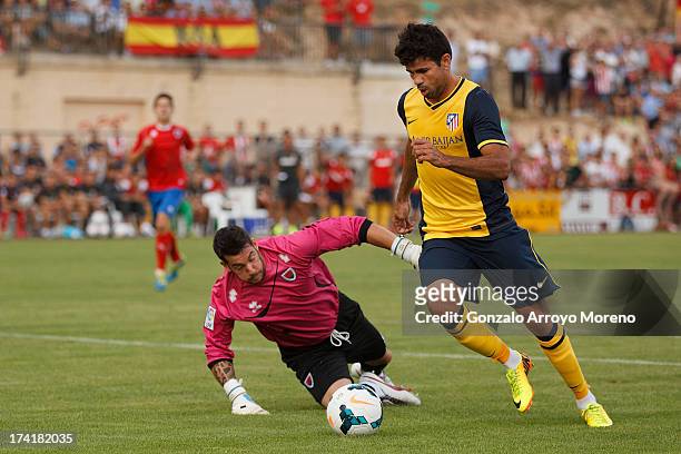 Diego Costa of Atletico de Madrid scores their second goal as he rounds goalkeeper Biel Ribas of Numancia CD during the Jesus Gil y Gil Trophy...