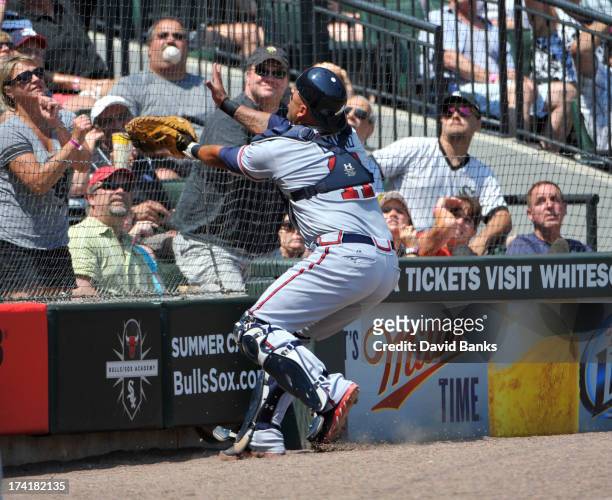 Gerald Laird of the Atlanta Braves catches a foul ball off the bat of Adam Dunn of the Chicago White Sox during the third inning on July 21, 2013 at...