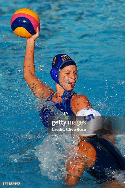 Victoria Muratore of Brazil looks to pass the ball under pressure from Gabriella Szucs of Hungary in the Women's Water Polo first preliminary round...