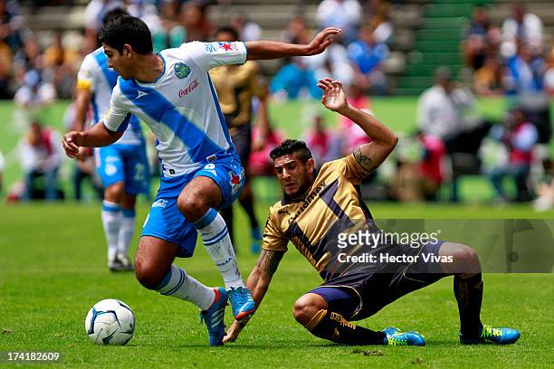 Omar Bravo of Pumas struggles for the ball with Diego de Buen of Puebla during a match between Pumas and Puebla as part of the Torneo Apertura 2013...