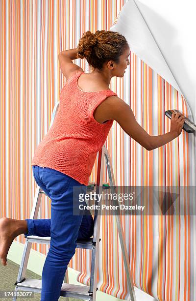 woman hanging wallpaper - hanging bildbanksfoton och bilder