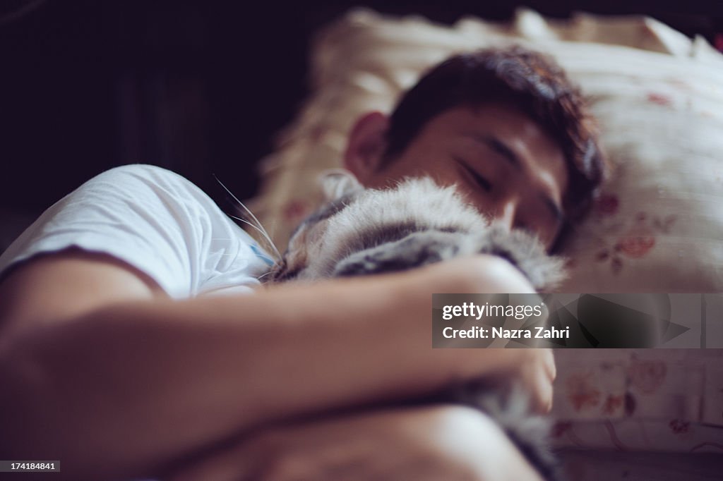 Pet owner hugging cat