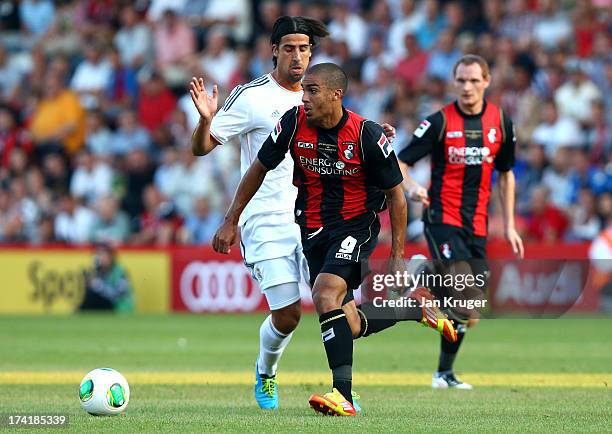 Lewis Grabban of AFC Bournemouth shields the ball from Sami Khedira of Real Madrid during a pre season friendly match between AFC Bournemouth and...