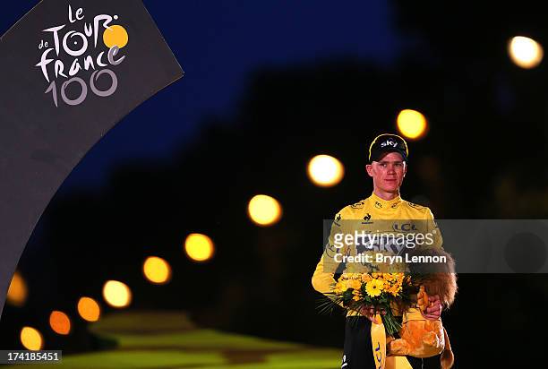 Winner of the 2013 Tour de France, Chris Froome of Great Britain and SKY Procycling celebrates on the podium after the twenty first and final stage...