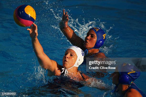 Ildiko Toth of Hungary in action with captain Marina Canetti and Melani Dias of Hungary during the Women's Water Polo first preliminary round match...