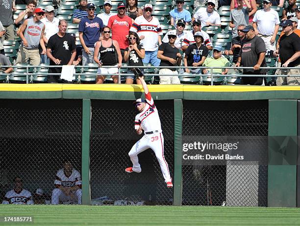 Casper Wells of the Chicago White Sox robs Reed Johnson of the Atlanta Braves of a home run during the eighth inning on July 21, 2013 at U.S....