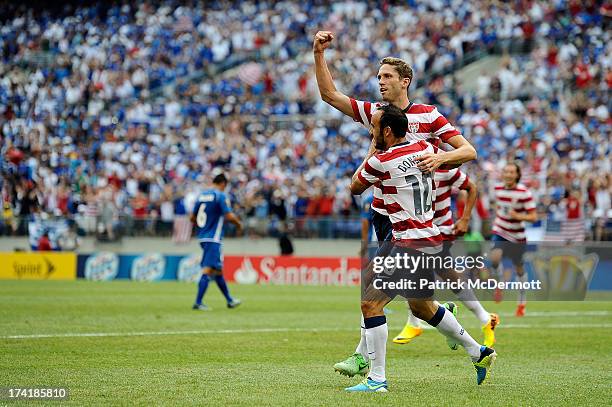 Clarence Goodson of the United States celebrates with Landon Donovan after scoring a goal against El Salvador in the first half during the 2013...