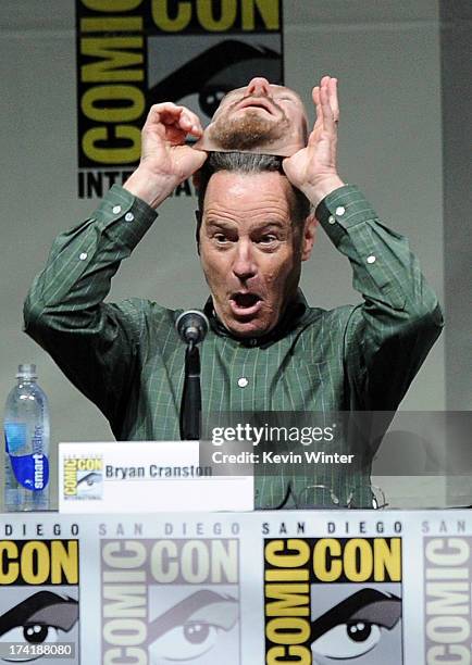 Actor Bryan Cranston pulls off his Walter White mask onstage at the "Breaking Bad" panel during Comic-Con International 2013 at San Diego Convention...