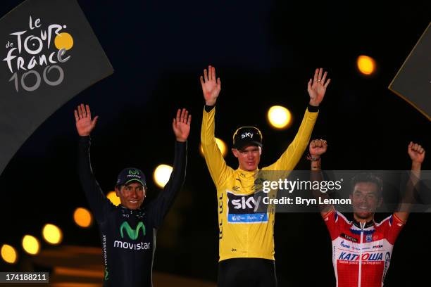 Winner of the 2013 Tour de France, Chris Froome of Great Britain and SKY Procycling celebrates on the podium alongside second placed, best young...