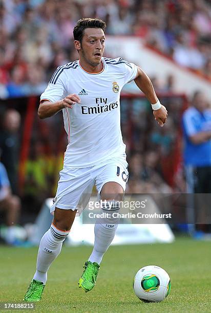 Mesut Ozil of Real Madrid attacks during the pre season friendly match between Bournemouth and Real Madrid at Goldsands Stadium on July 21, 2013 in...