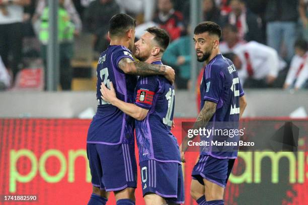 Lionel Messi of Argentina celebrates with teammates Cristian Romero and Nicolas Gonzalez after scoring the team´s first goal during a FIFA World Cup...