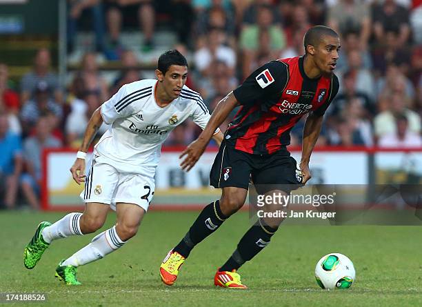 Lewis Grabban of AFC Bournemouth shields the ball from Angel di Maria of Real Madrid during a pre season friendly match between AFC Bournemouth and...