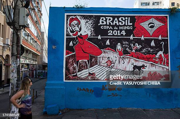 Woman looks at a wall painted by Chilean-born Brazilian painter Jorge Selaron on the FIFA World Cup Brazil 2014 in Rio de Janeiro, Brazil on July 21,...