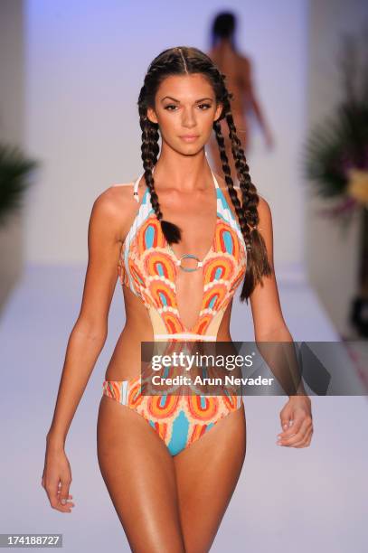 Model walks the runway during the Aqua Di Lara fashion show at Mercedes-Benz Fashion Week Swim 2014 at Raleigh Hotel on July 20, 2013 in Miami Beach,...