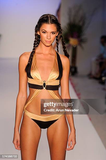 Model walks the runway during the Aqua Di Lara fashion show at Mercedes-Benz Fashion Week Swim 2014 at Raleigh Hotel on July 20, 2013 in Miami Beach,...