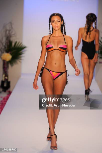 Model walks the runway during the Aqua Di Lara fashion show at Mercedes-Benz Fashion Week Swim 2014 at Raleigh Hotel on July 20, 2013 in Miami Beach,...