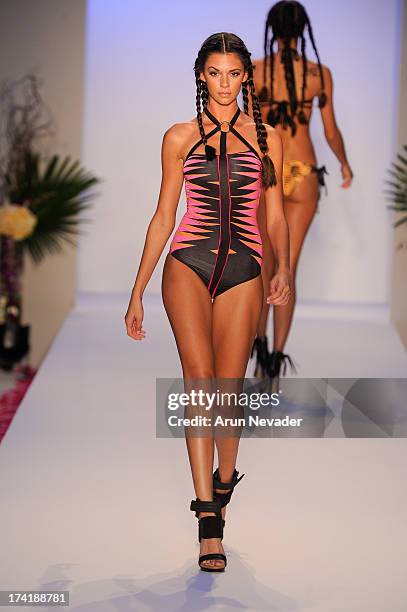 Model walks the runway during the Aqua Di Lara fashion show at Mercedes-Benz Fashion Week Swim 2014 at Raleigh Hotel on July 20, 2013 in Miami Beach,...