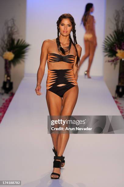 Model walks the runway during the Aqua Di Lara fashion show at Mercedes-Benz Fashion Week Swim 2014 at Raleigh Hotel on July 20, 2013 in Miami Beach,...