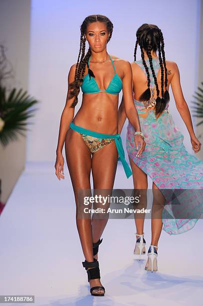 Model walks the runway during the Aqua Di Lara fashion show at Mercedes-Benz Fashion Week Swim 2014 at Raleigh Hotel on July 20, 2013 in Miami Beach,...