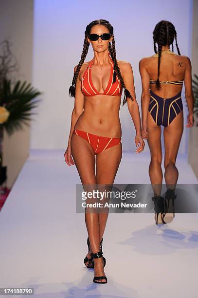 Model walks the runway during the Aqua Di Lara fashion show at Mercedes-Benz Fashion Week Swim 2014 at Raleigh Hotel on July 20, 2013 in Miami Beach,...
