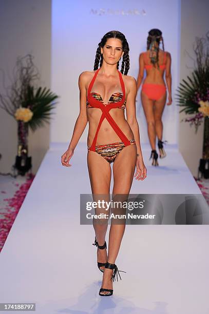 Model walks the runway during the Aqua Di Lara fashion show at Mercedes-Benz Fashion Week Swim 2014 at Raleigh Hotel on July 20, 2013 in Miami Beach,...