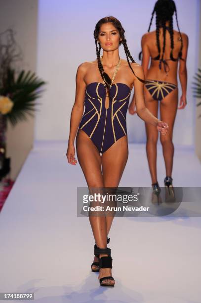 Model walks the runway during the Aqua Di Lara fashion show at Mercedes-Benz Fashion Week Swim 2014 at Raleigh Hotel on July 20, 2013 in Miami Beach,...