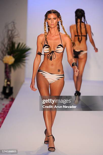 Model walks the runway during the Aqua Di Lara fashion show at Mercedes-Benz Fashion Week Swim 2014 at Raleigh Hotel on July 20, 2013 in Miami Beach,...