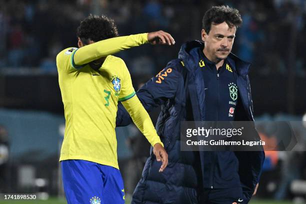 Marquinhos and Fernando Diniz, head coach of Brazil, react after losing the FIFA World Cup 2026 Qualifier match between Uruguay and Brazil at...