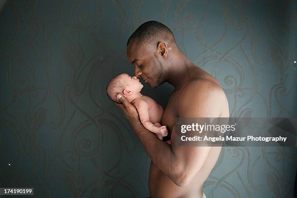 newborn baby girl with dad - muscle black wallpaper stock pictures, royalty-free photos & images