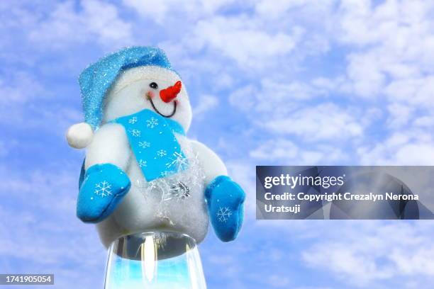 snowman with santa claus hat,hand warmer gloves and neck gaiter (7) ib beautiful sky background - buff stock pictures, royalty-free photos & images