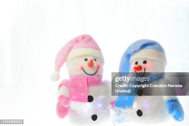 snowman with santa claus hat,hand warmer gloves and neck gaiter (6) in a white background of curtain - buff stock pictures, royalty-free photos & images