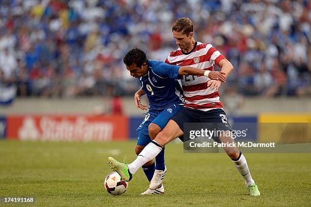 Clarence Goodson of the United States battles for the ball against Rafael Burgos of El Salvador in the second half during the 2013 CONCACAF Gold Cup...