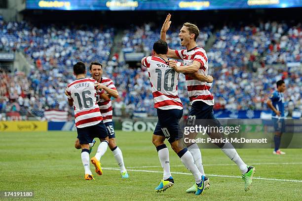 Clarence Goodson of the United States celebrates with Landon Donovan after scoring a goal against El Salvador in the first half during the 2013...