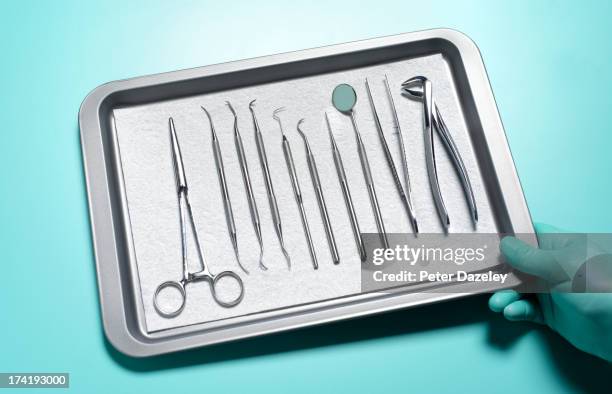 dentist with tray of instruments - extraction forceps stockfoto's en -beelden