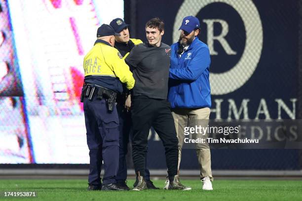 Fan is stopped by security after trying to run on the field after the Philadelphia Phillies defeated the Arizona Diamondbacks 10-0 in Game Two of the...