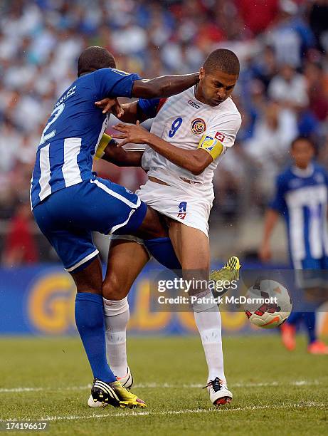Osman Chavez of Honduras battles for the ball against Alvaro Saborio of Costa Rica in the first half during the 2013 CONCACAF Gold Cup quarterfinal...