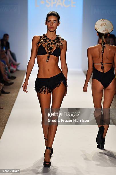 Model walks the runway at the L*Space By Monica Wise show during Mercedes-Benz Fashion Week Swim 2014 at Cabana Grande at the Raleigh on July 21,...