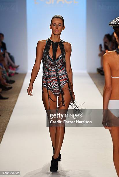 Model walks the runway at the L*Space By Monica Wise show during Mercedes-Benz Fashion Week Swim 2014 at Cabana Grande at the Raleigh on July 21,...