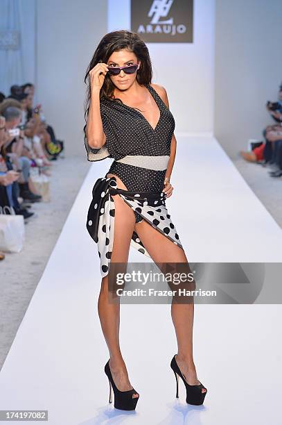 Personality Adriana De Moura walks the runway at the A.Z. Araujo show during Mercedes-Benz Fashion Week Swim 2014 at Oasis at the Raleigh on July 21,...