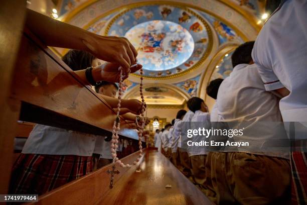 Filipino children pray the rosary as they take part in the "One Million Children Praying the Rosary for Unity and Peace" campaign, at the Immaculate...