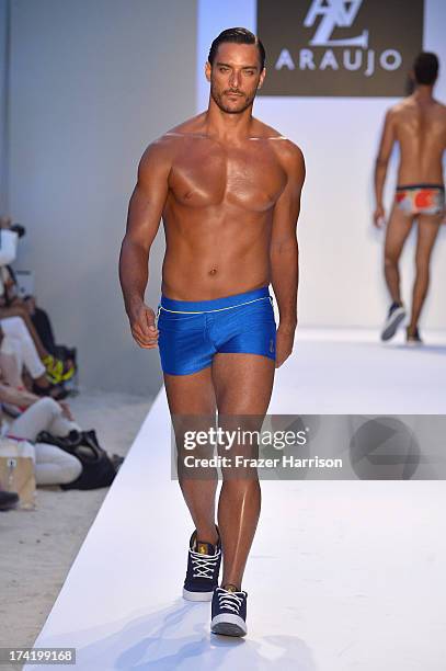 Model walks the runway at the A.Z. Araujo show during Mercedes-Benz Fashion Week Swim 2014 at Oasis at the Raleigh on July 21, 2013 in Miami, Florida.